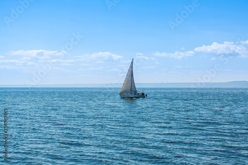 Yacht sailing on calm water.