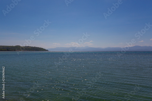 sunlight glitter reflection on the water waves at the sea in light afternoon sunshine 