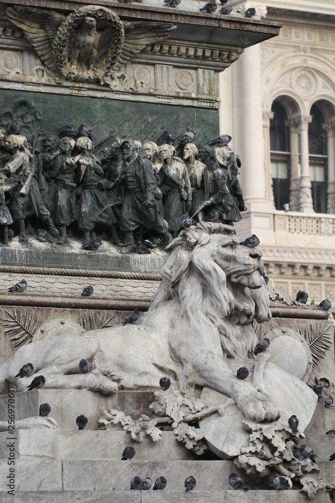 Group of Pigeons on Lion head statue at Piazza Duomo of Milano Italy, dirty from bird pooping shit on attractive sculpture art, travel destination backgrounds