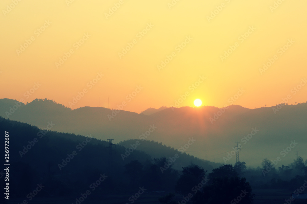 Sunrise over the mountain on the foggy morning - Natural background