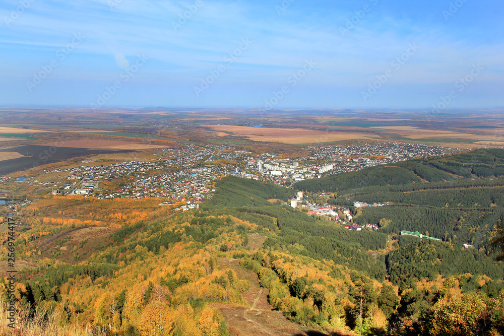 Golden autumn in the Altai region in Russia. Beautiful landscape - road in autumn forest