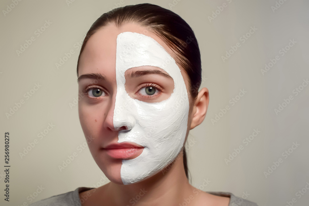 Cosmetic mask on half of the face. The concept of spa, beauty and skin care. Female face with a cosmetic mask. Cosmetic mask on half of the face. The concept of spa, beauty and skin care. Female face with a cosmetic mask.