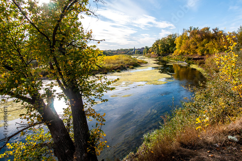 river slipping into the distance in yellow, autumn colors