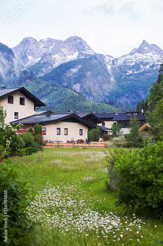 An old, vintage, wooden house is located in the Alps