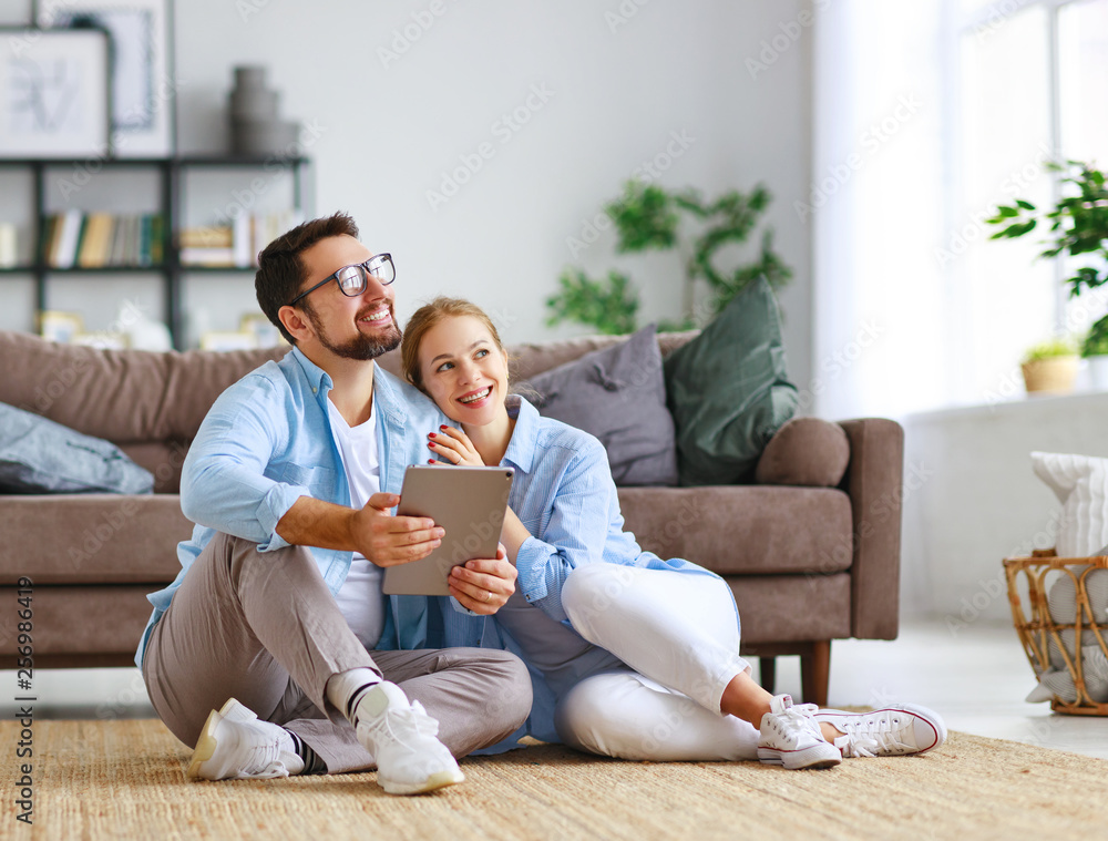 concept of moving, buying home. married couple plans to repair and project apartment. . concept of moving, buying home. married couple plans to repair and project apartment. .