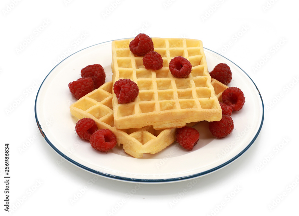 fresh belgian waffles with raspberrys on a plate isolated on white background fresh belgian waffles with raspberrys on a plate isolated on white background
