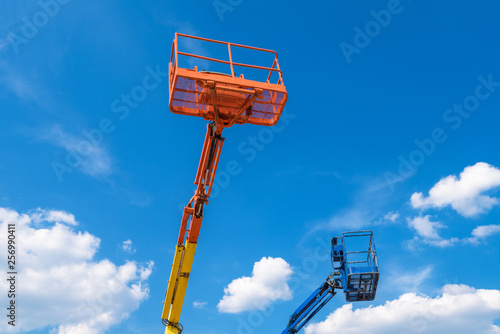 Obraz na plátně Cherry pickers on blue sky background