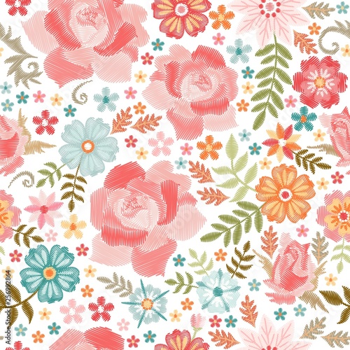 Beautiful seamless pattern with embroidery roses and wild flowers on white background. Fashion print for summer clothing.