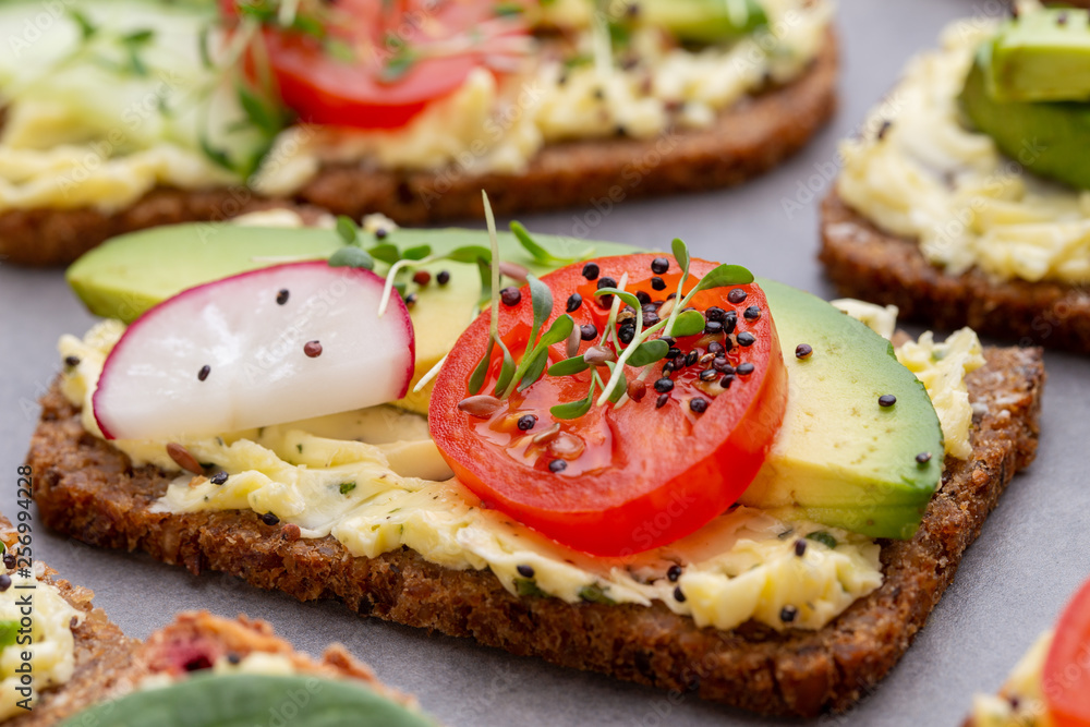 Sandwiches with cream cheese, vegetables and salami.