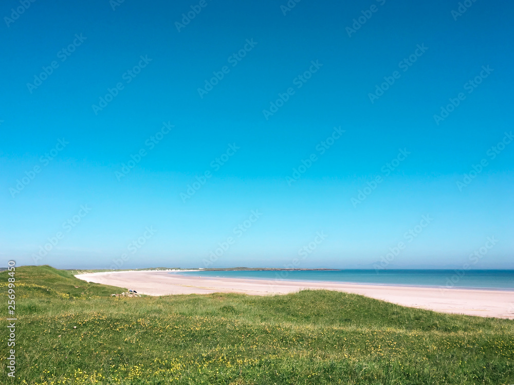 Beach in the Inner Hebrides in the sun with turquoise sky Beach in the Inner Hebrides in the sun with turquoise sky