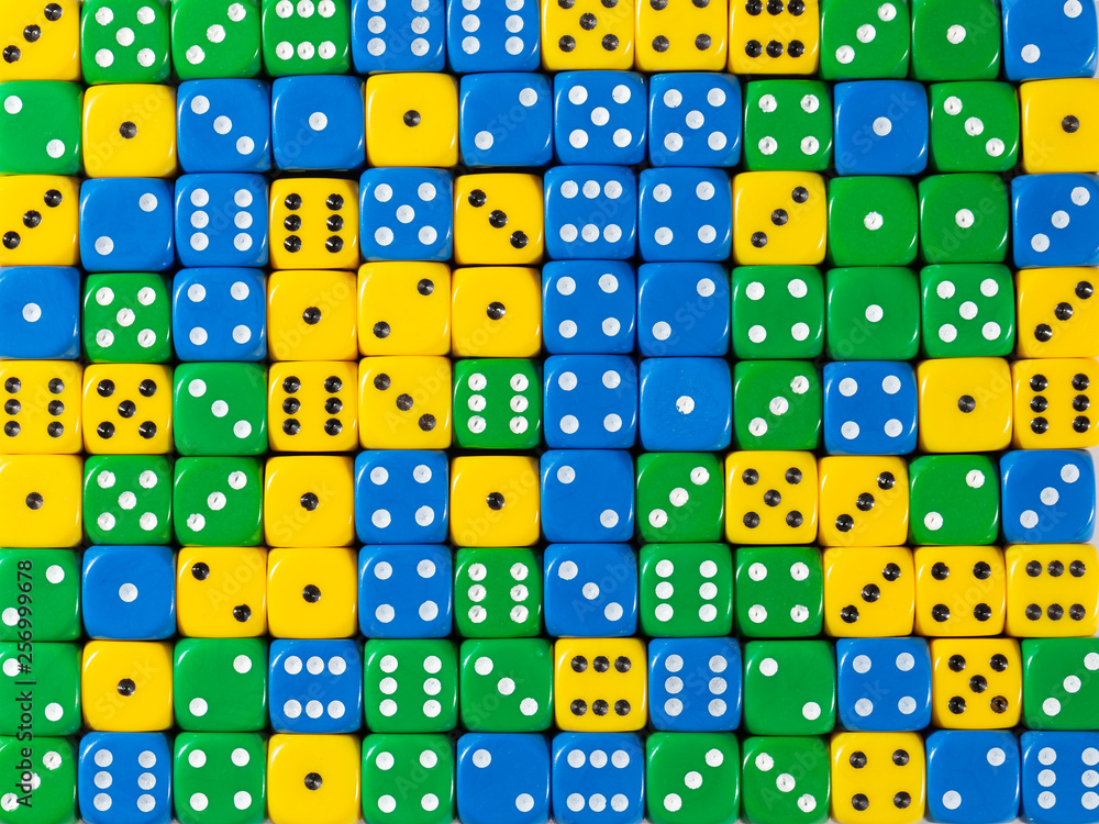 Background pattern of random ordered yellow, green and blue dices Background pattern of random ordered yellow, green and blue dices