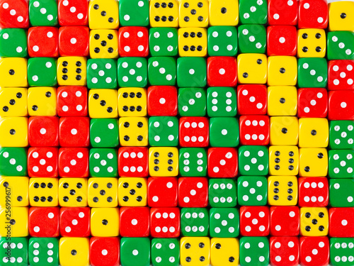 Background pattern of random ordered red, green and yellow dices