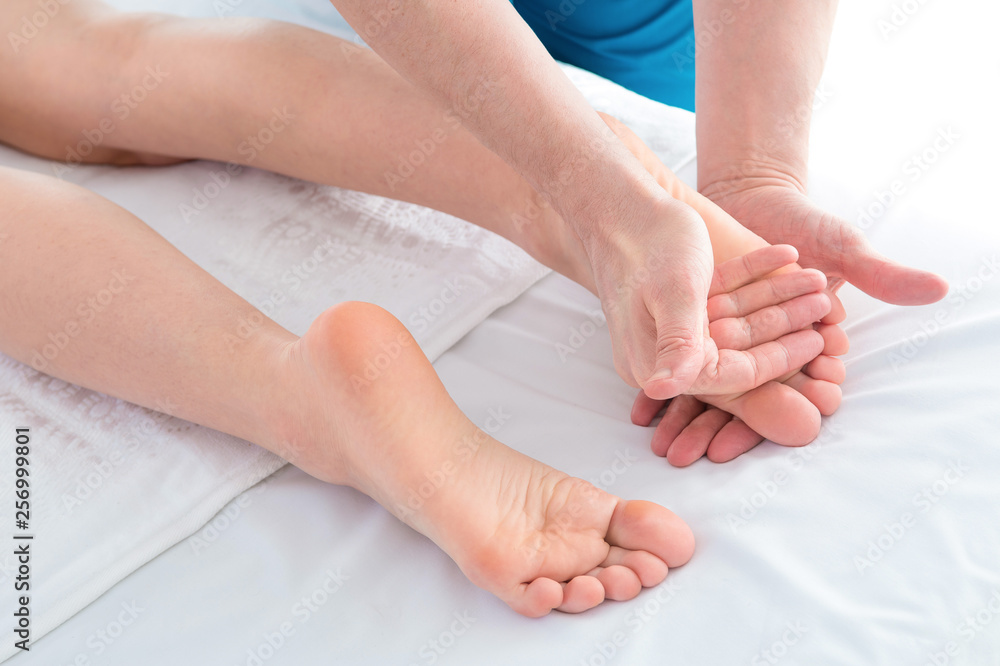 Woman getting a foot massage at a health spa. Woman getting a foot massage at a health spa.