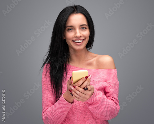 Elegant woman with smartphone smiling