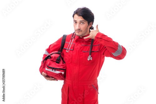 Young paramedic in red uniform isolated on white © Elnur