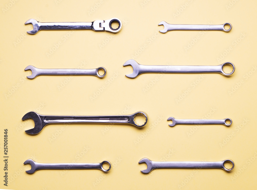 A few wrenches on a yellow background. A few wrenches on a yellow background.