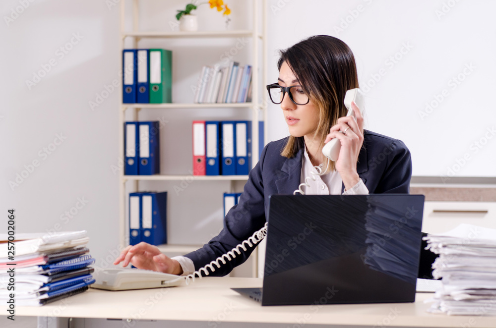 Young female employee working in the office Young female employee working in the office