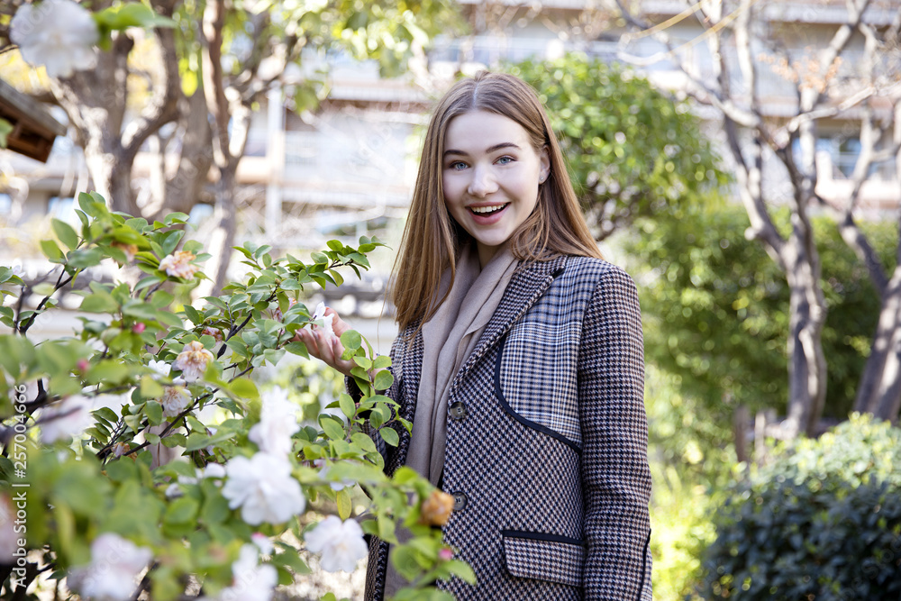 Young long hair girl model of clothes in the garden in spring posing Young long hair girl model of clothes in the garden in spring posing
