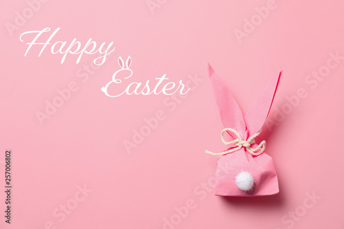 Creative Easter bunny gift bag on color background  top view with space for text
