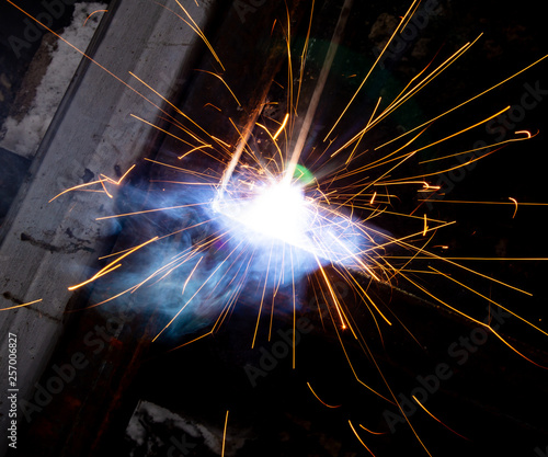 Sparks from welding at a construction site as a background