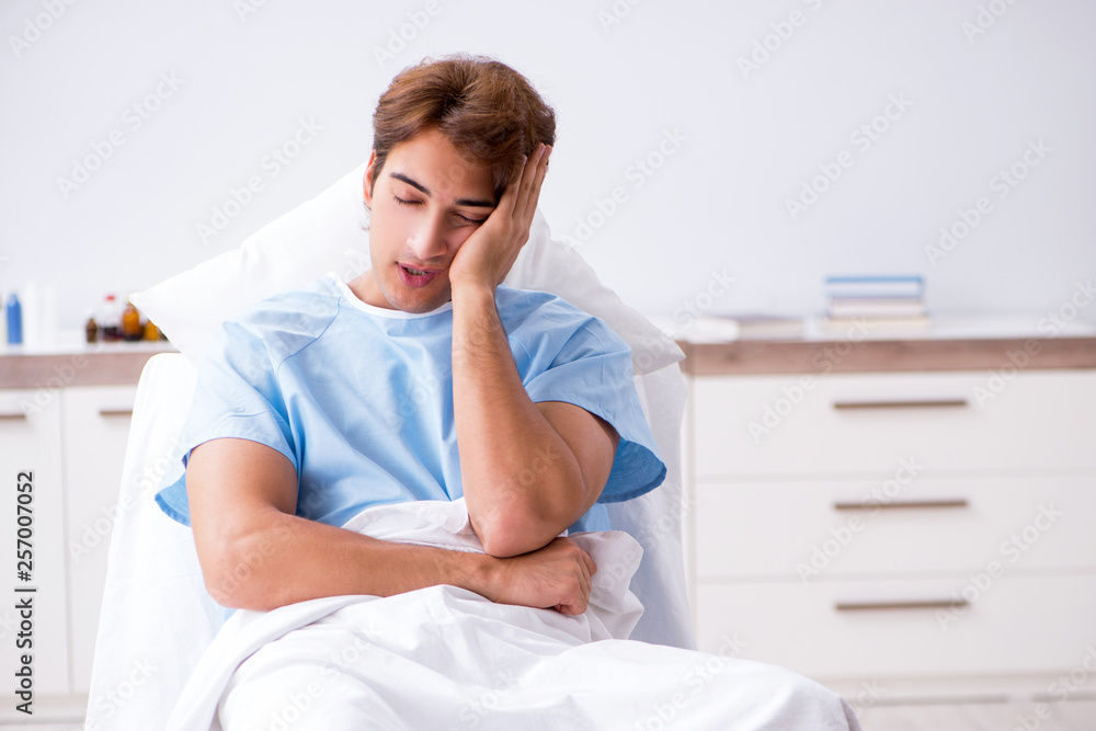 Young male patient lying on couch in hospital