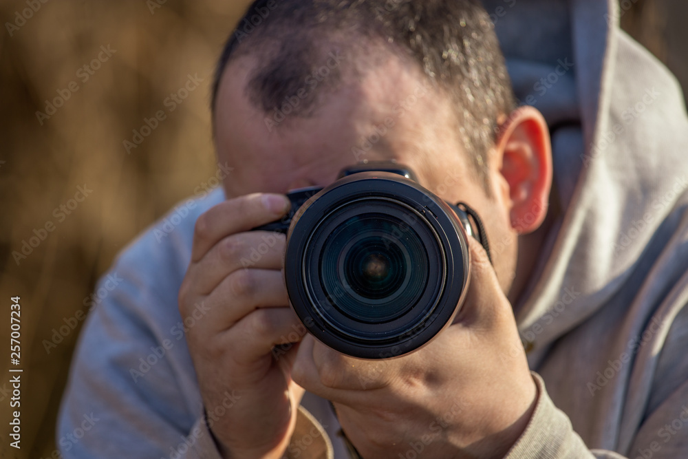 A man takes pictures with a camera in his hands A man takes pictures with a camera in his hands