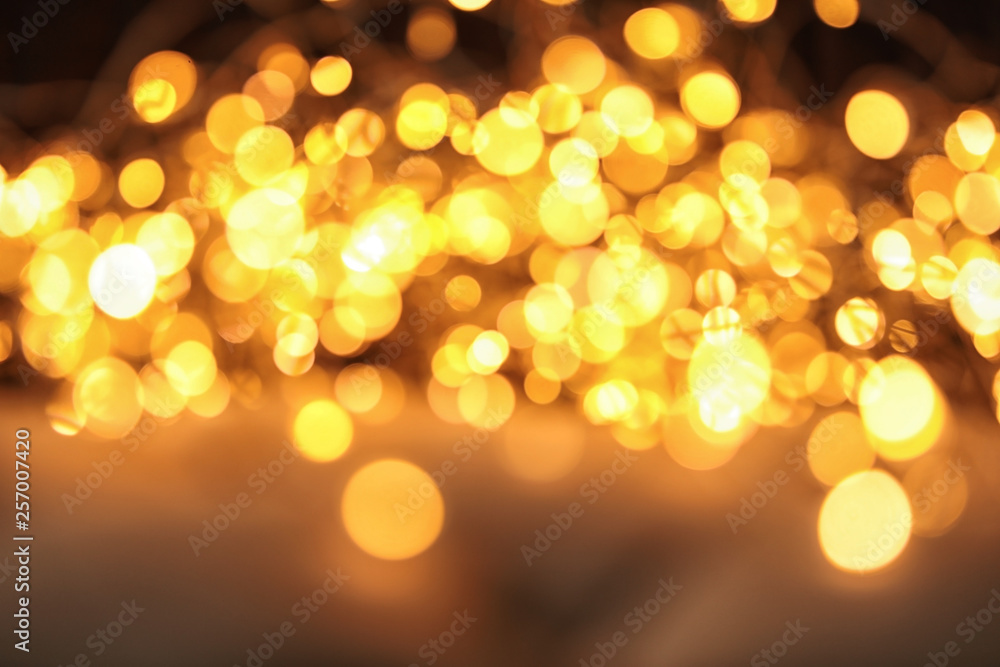 Gold glitter with bokeh effect on dark background Gold glitter with bokeh effect on dark background
