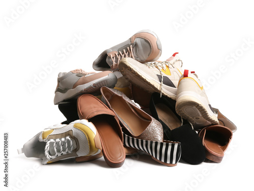 Pile of different shoes on white background