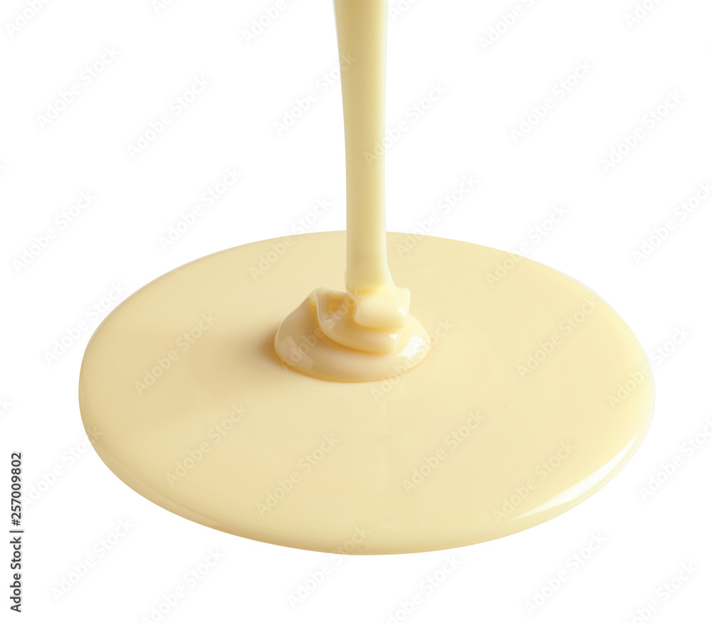 Tasty pouring condensed milk on white background. Dairy product Tasty pouring condensed milk on white background. Dairy product