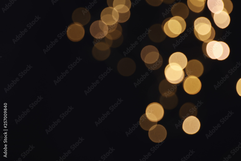 Beautiful golden lights on dark background. Bokeh effect - obrazy, fototapety, plakaty 
