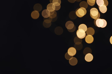 Beautiful golden lights on dark background. Bokeh effect