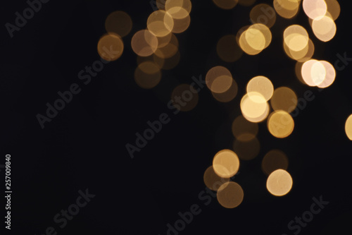Beautiful golden lights on dark background. Bokeh effect photo