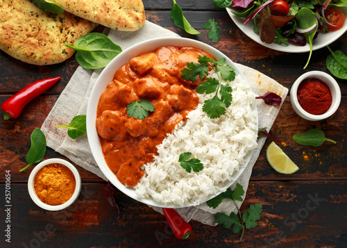 Chicken tikka masala curry with rice and naan bread photo