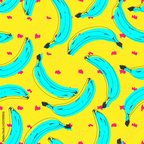 Seamless pop art banana pattern randomly distributed on color background.