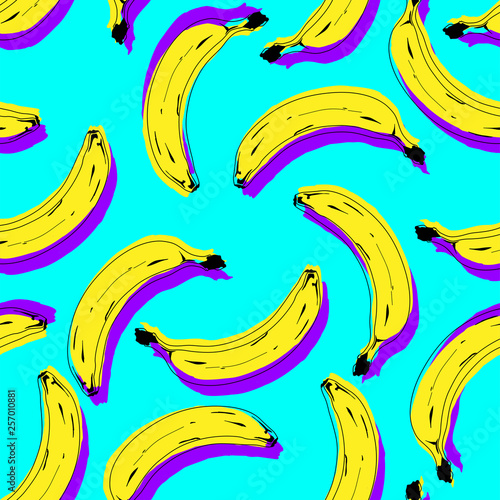 Seamless pop art banana pattern randomly distributed on color background.