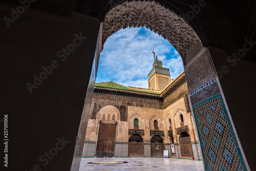 FES, MOROCCO - November 16, 2018: The minaret view and Inside interior of The Madrasa Bou Inania ( Medersa el Bouanania ) is acknowledged as an excellent example of Marinid architecture. Fes el Bali