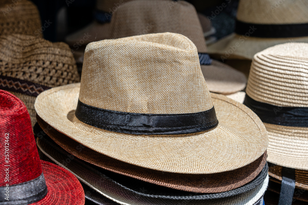 Straw hats on display for sale to tourists on street local market in Ubud, island Bali, Indonesia, closeup