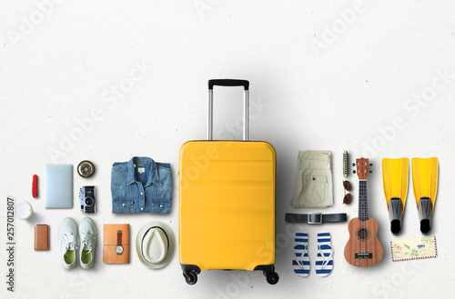Travel concept with a large suitcase and other accessories