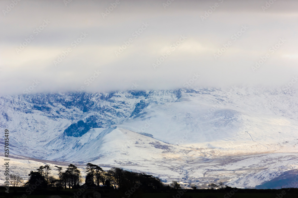 View of the spectacular snow-covered Snowdonia Mountain Range from Pentraeth on the Isle of Anglesey