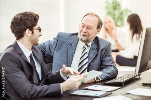 members of a business team discussing business documents in the workplace in the office