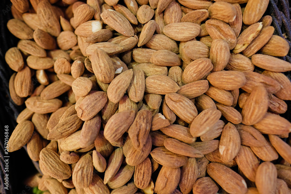 Fototapeta premium Organic almond nuts as background, top view. Healthy snack
