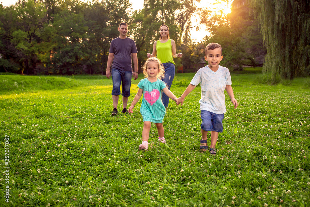 Funny time - family having fun together at park. Funny time - family having fun together at park.