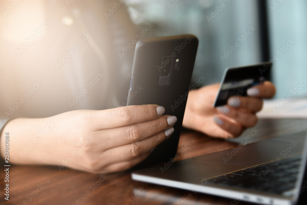 Woman hands holding smart phone and using credit card for online shopping.Online shopping concept.Close up Woman hands holding smart phone and using credit card for online shopping.Online shopping concept.Close up