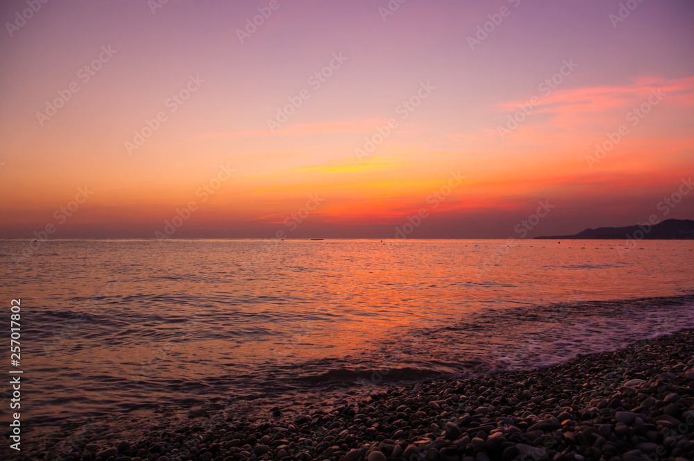 Fototapeta premium Amazing sea sunset, the sun, waves, clouds