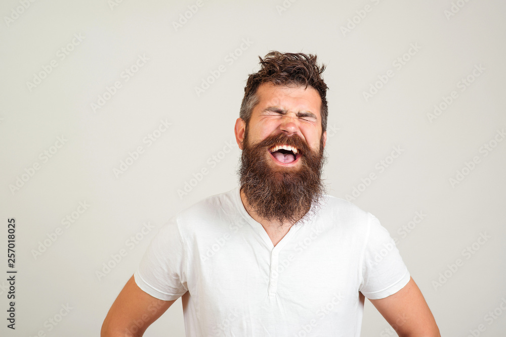 Stylish happy bearded man with closed eyes shouting on white background. Male excited face expression. Handsome bearded guy screaming. Stylish happy bearded man with closed eyes shouting on white background. Male excited face expression. Handsome bearded guy screaming.