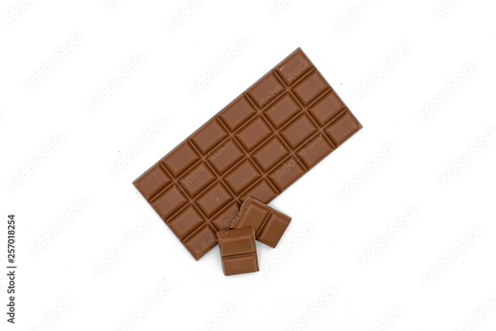 Milk chocolate bar and chocolate pieces isolated on white background Milk chocolate bar and chocolate pieces isolated on white background