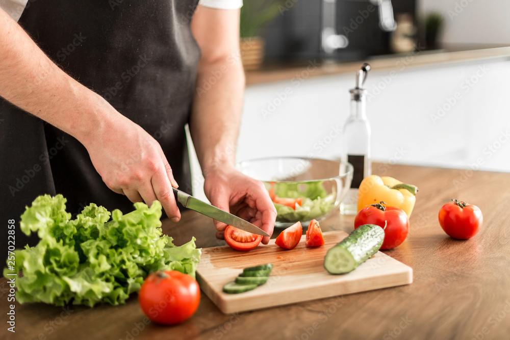 Young trendy man cooking healthy food in the morning Young trendy man cooking healthy food in the morning