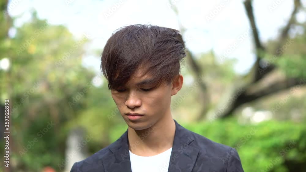 Front Tracking Shot - Successful Young Asian Businessman in Suit Taking Call on Smartphone Front Tracking Shot - Successful Young Asian Businessman in Suit Taking Call on Smartphone