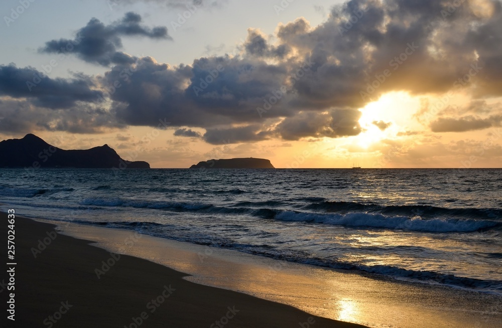 Sunset on the island of Porto Santo, view from the sandy beach of the Atlantic Ocean, Portugal