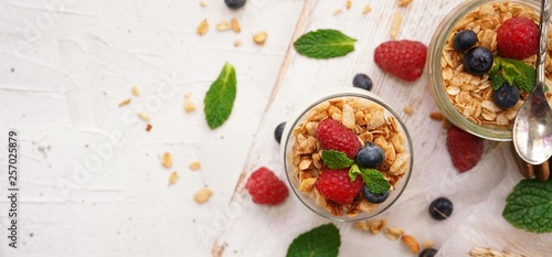 Healthy Breakfast Granola Yogurt Parfait with fresh fruits and berries, selective focus